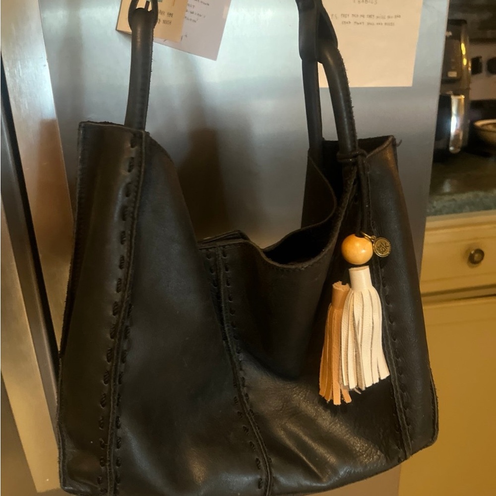 The Sak Black Leather Crossbody Bag with Tassel Charm